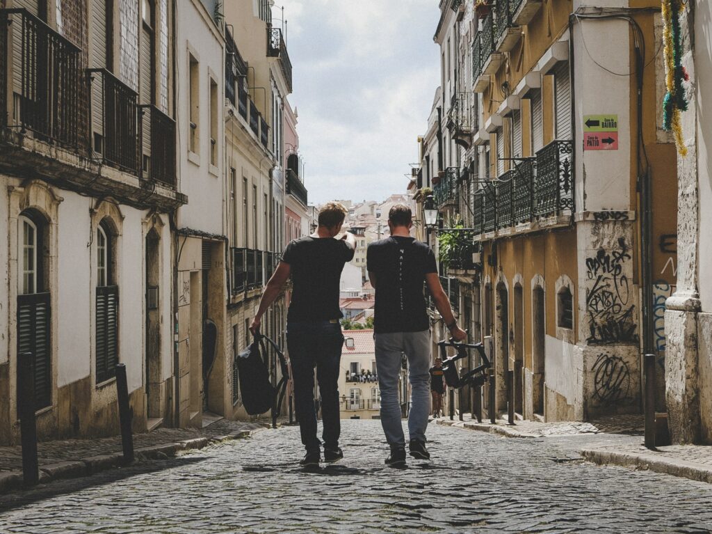 two friends walking on a street 