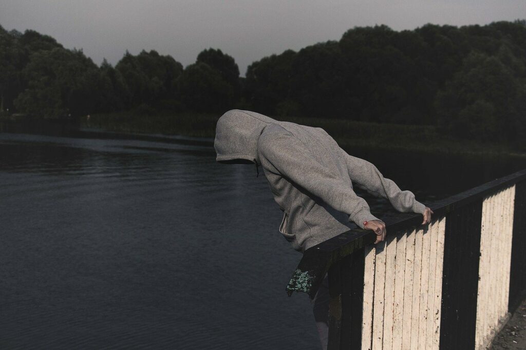 man on the edge of a bridge