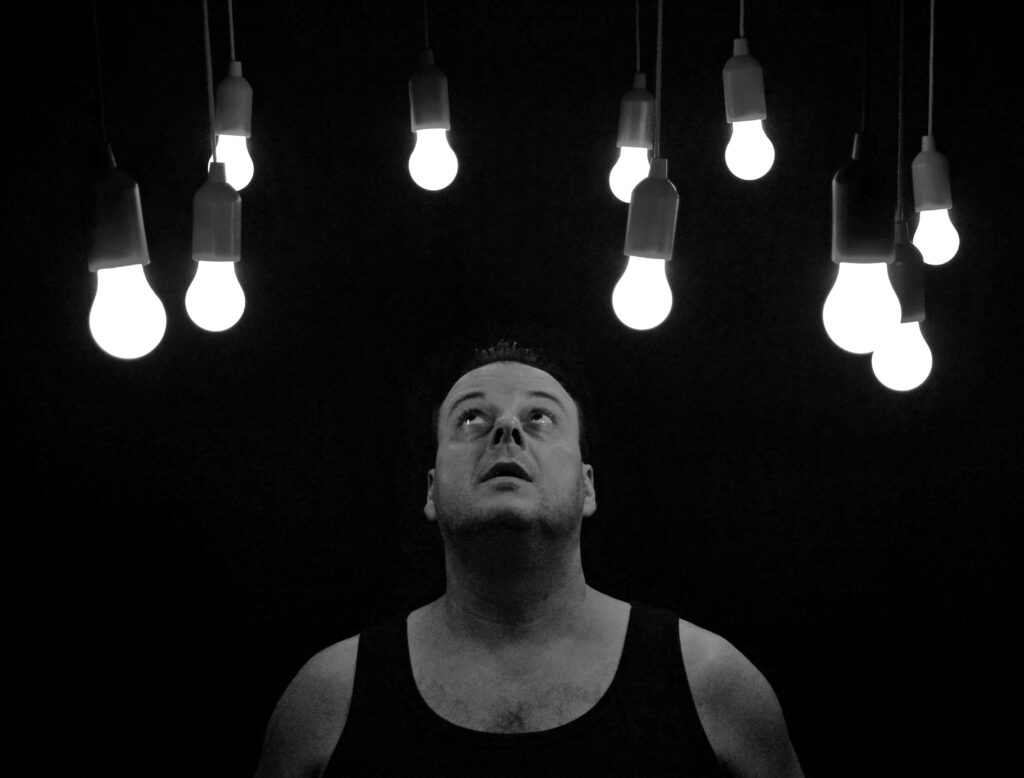 man starring at bulbs 