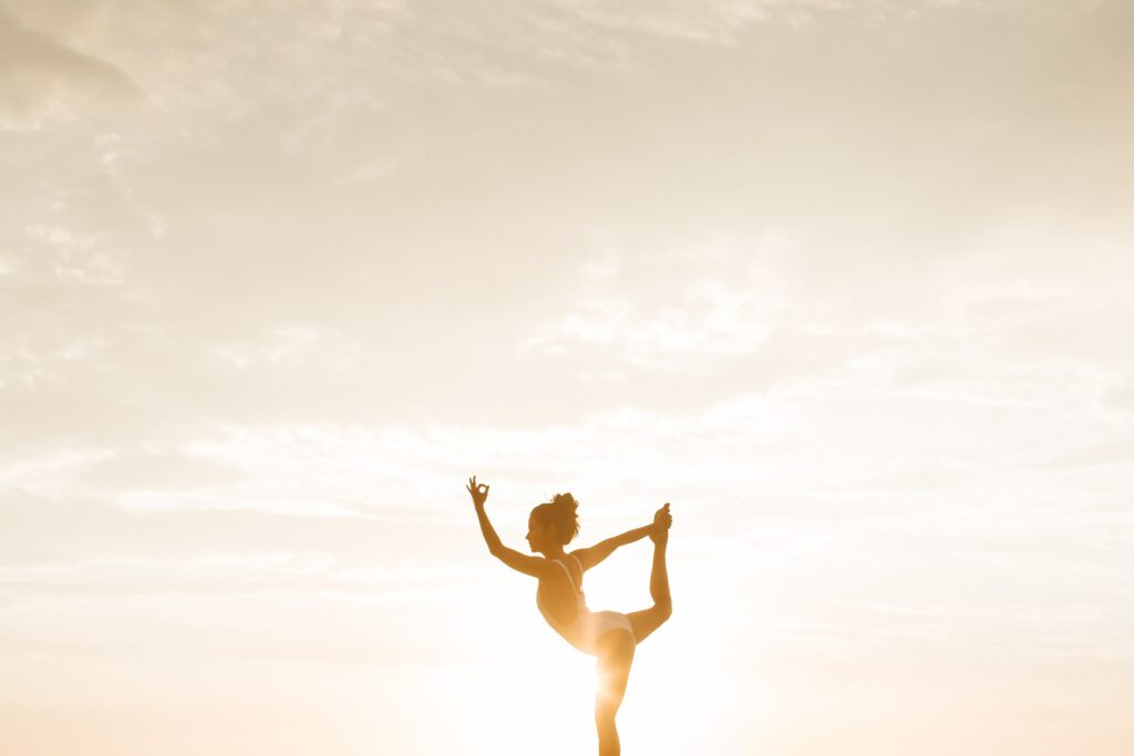 yoga pose with sun in background 